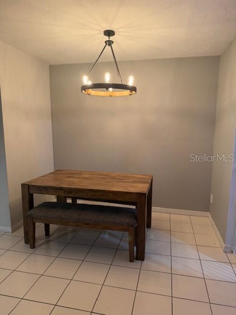 A dining area features a wooden table with a bench under a circular chandelier — 823 LONG MEADOW COURT, PORT ORANGE, FL