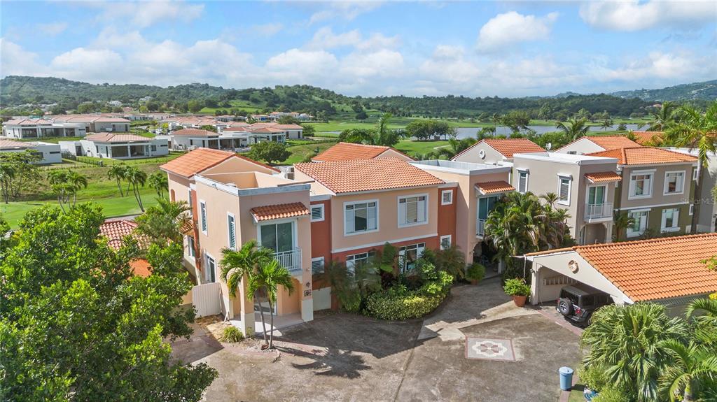 An aerial view of a two-story stucco house with a tiled roof and attached garage — 30 FLAMBOYAN GREENS, HUMACAO, PR