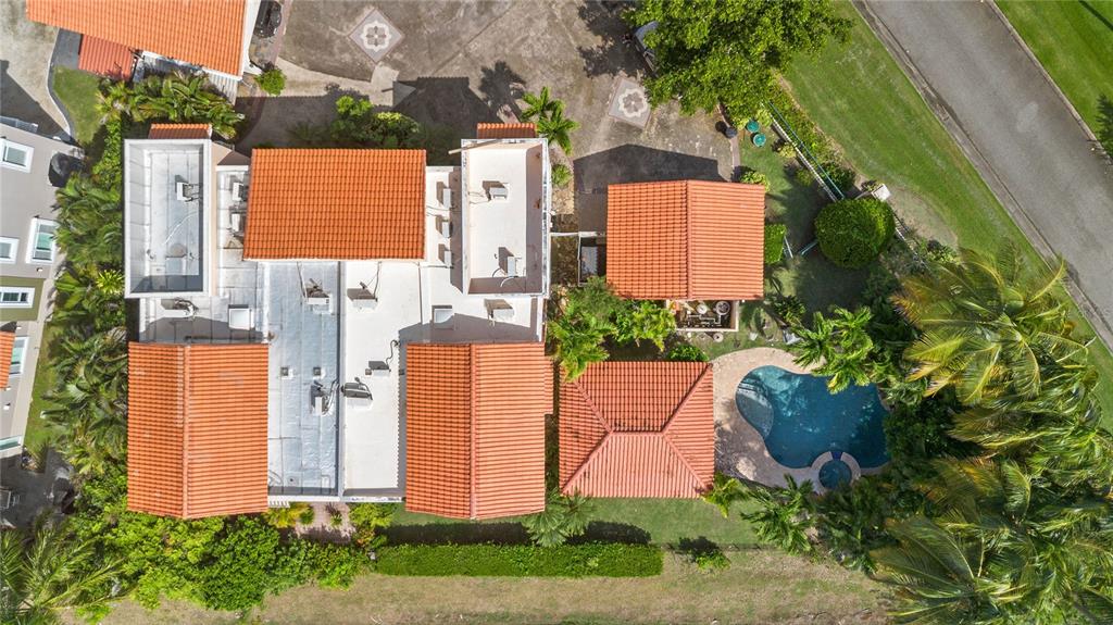 An aerial view shows a house with red tile roofs, a swimming pool, and landscaping — 30 FLAMBOYAN GREENS, HUMACAO, PR