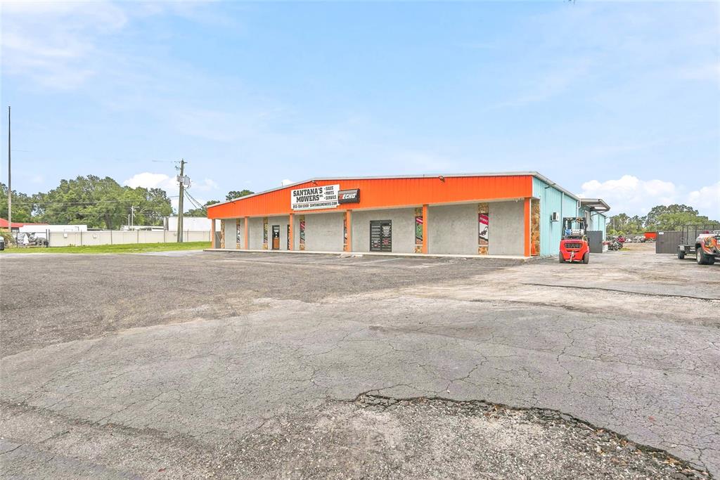 A commercial building with an orange roof and a large paved parking lot — 13295 92 HIGHWAY, DOVER, FL