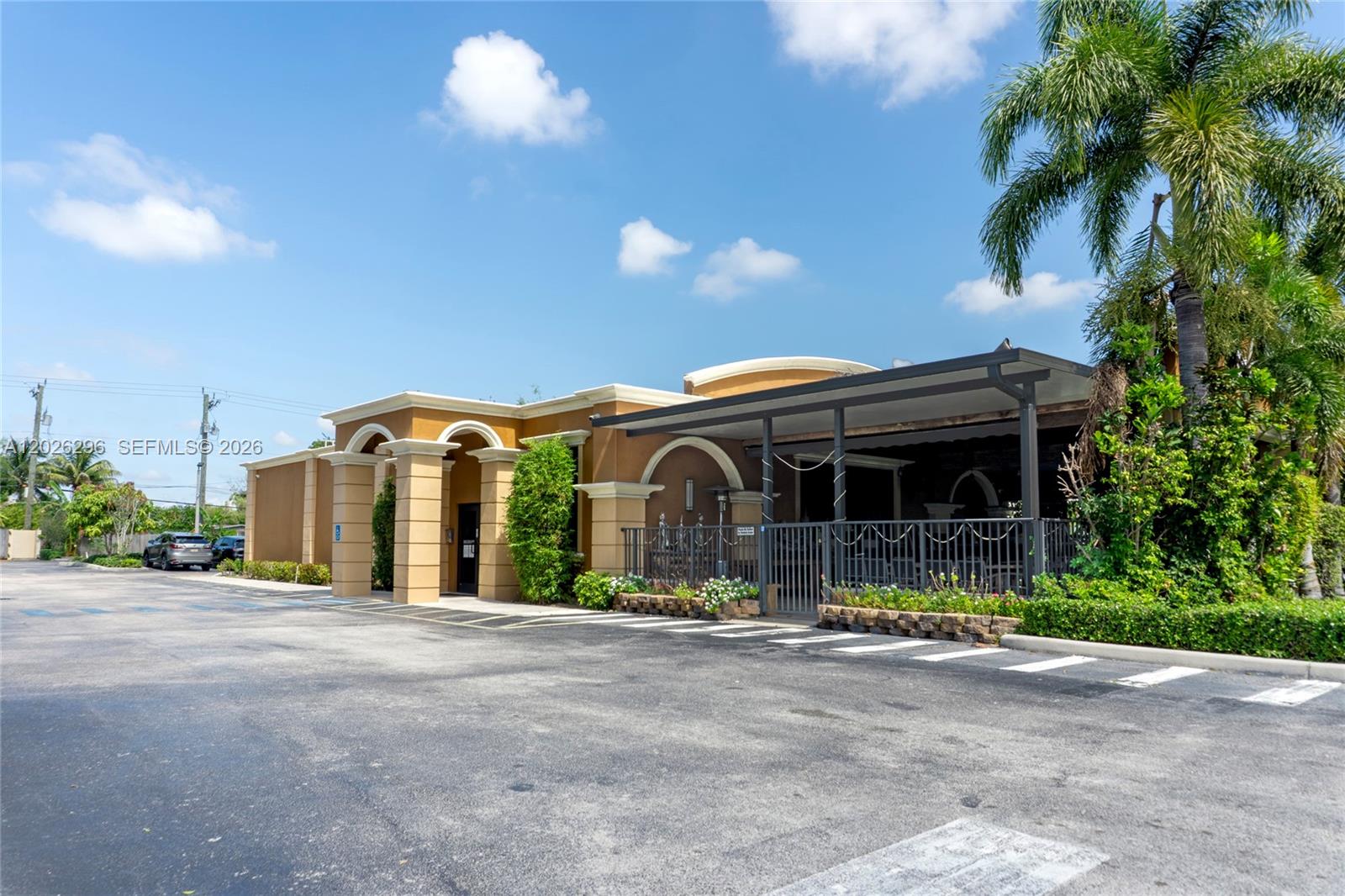 A tan commercial building features a covered patio area and an adjacent parking lot — 1785 N State Road 7, Margate FL 33063, MARGATE, FL