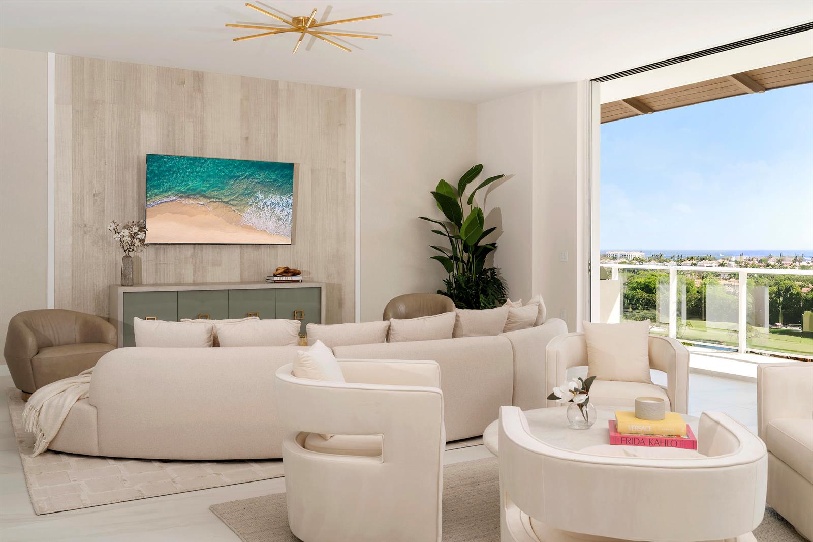 A modern living room features a curved sofa, neutral furniture, and a balcony with ocean views — 220 SE Mizner Boulevard, Boca Raton FL 33432, BOCA RATON, FL