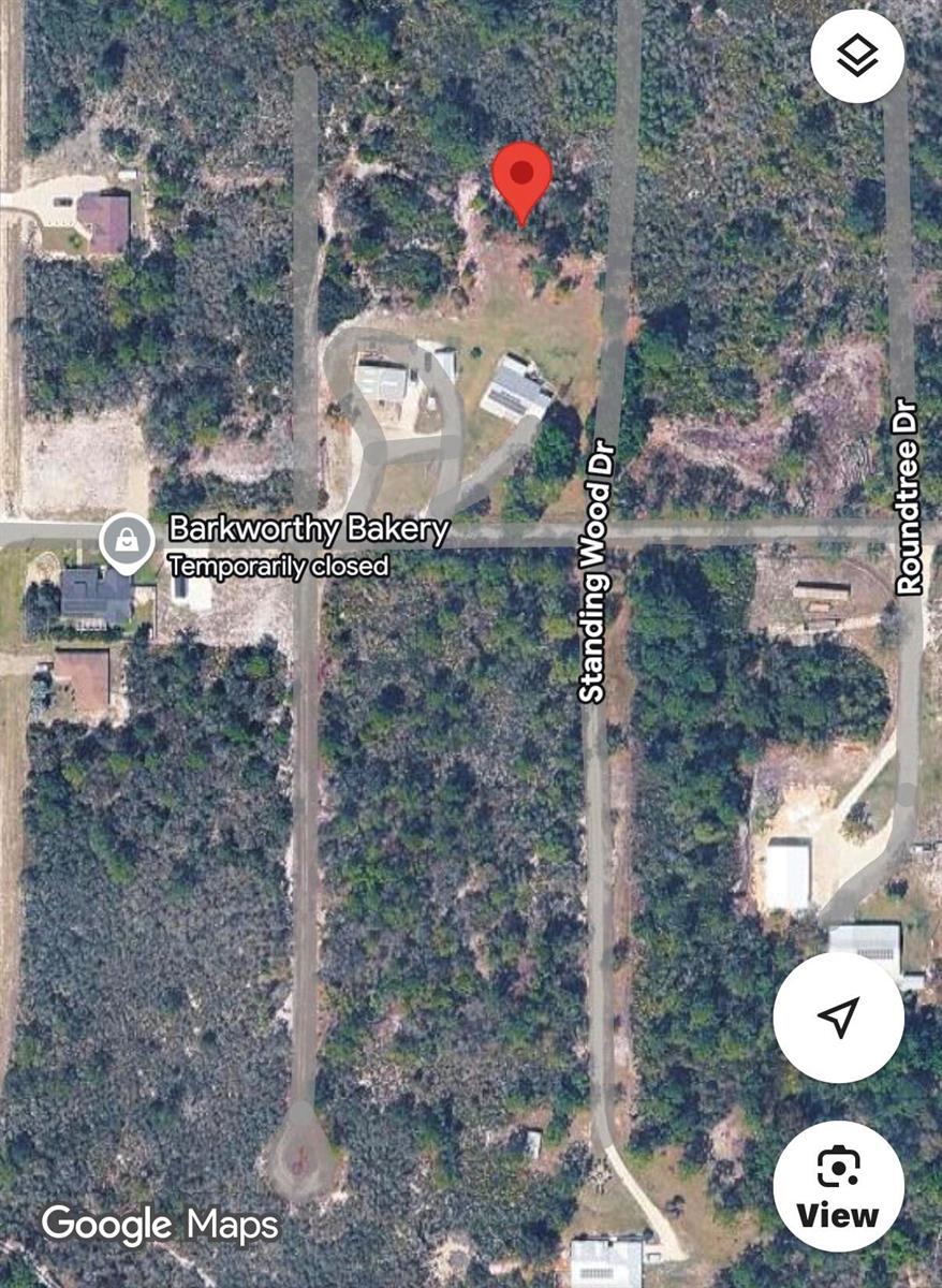 This is a satellite map view showing a residential lot with a house and driveway — 10131 Standing Woods Drive, Sebring FL 33875, SEBRING, FL