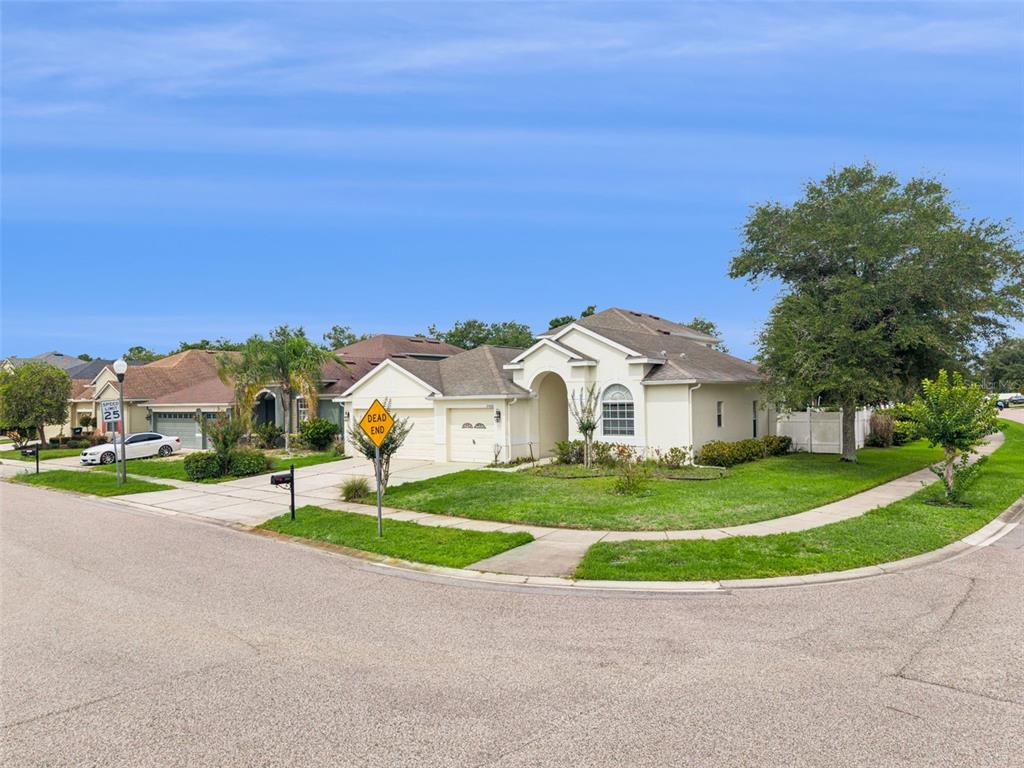 A single-story suburban house with a tan exterior sits on a corner lot — 2066 GLORIA OAK COURT, ORLANDO, FL