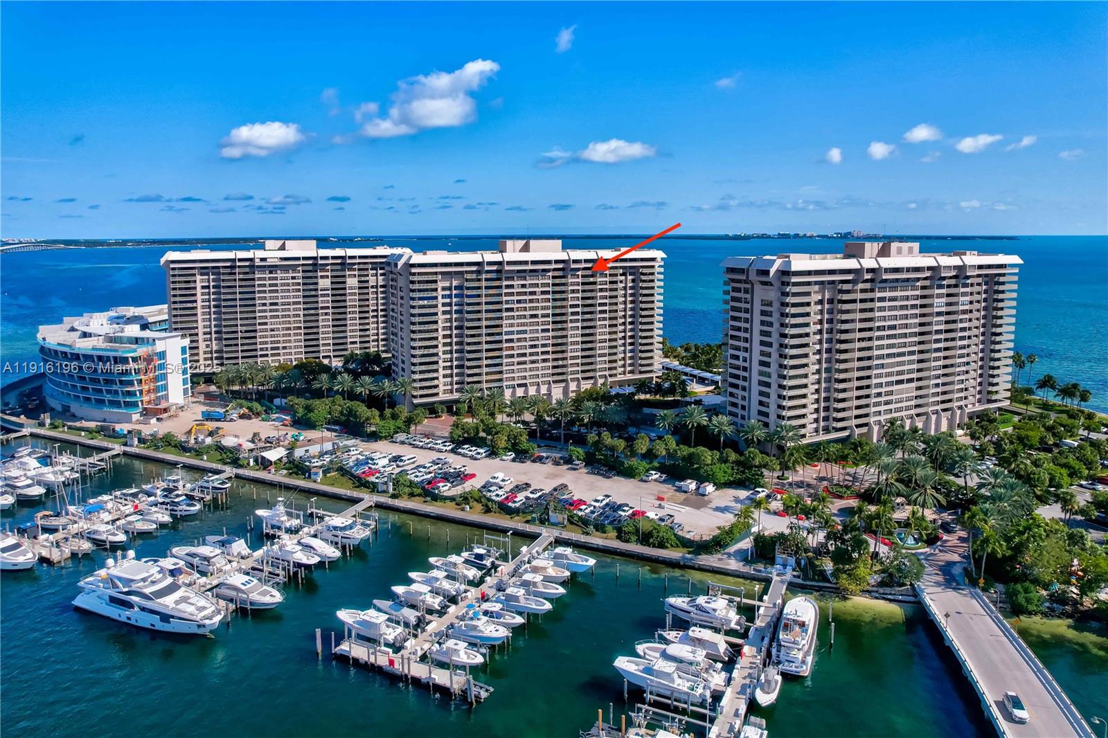 An aerial view shows high-rise residential buildings, a marina with docked boats, and a parking lot — 2 Grove Isle Dr # B1804, Coconut Grove FL 33133, COCONUT GROVE, FL