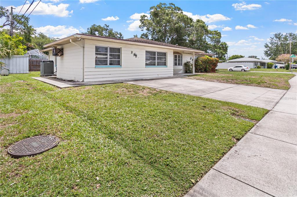 A single-story house with white siding, a concrete driveway, and a front lawn — 5331 98TH WAY N, ST PETERSBURG, FL