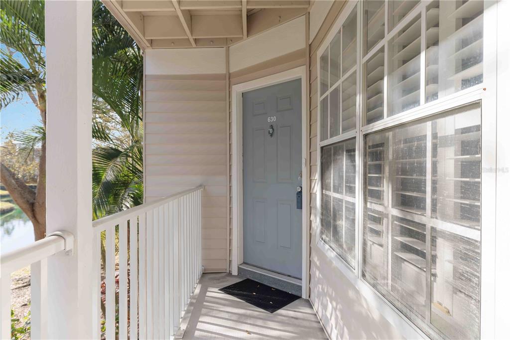 A light blue front door with the number 630 sits on a covered outdoor balcony — 850 S TAMIAMI TRAIL UNIT 630, SARASOTA, FL