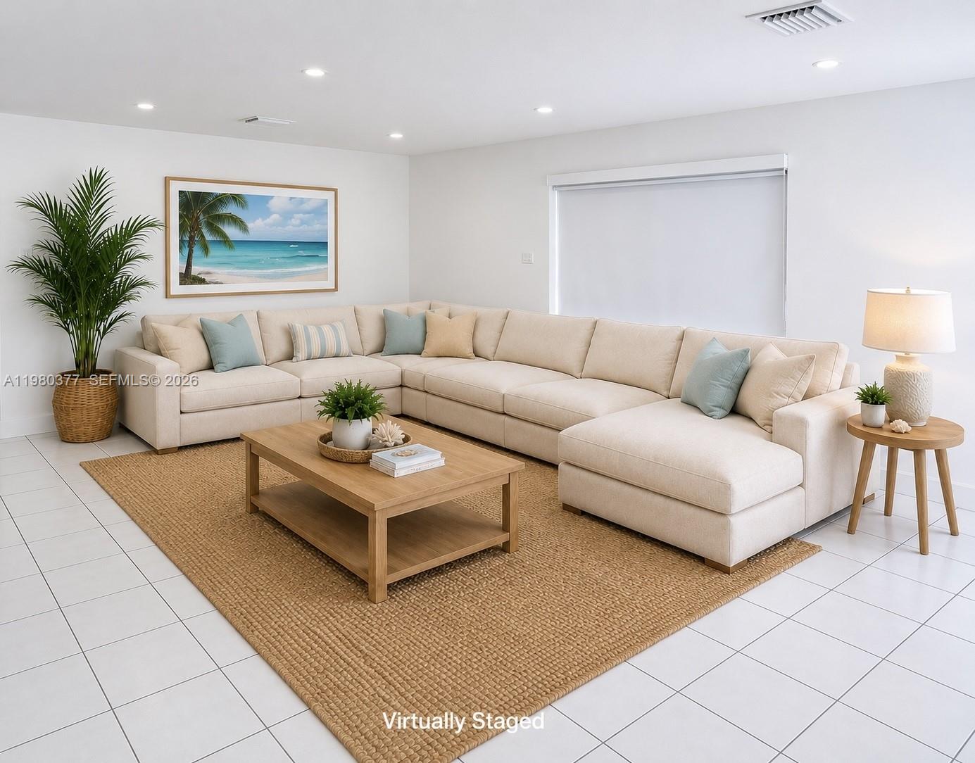 This virtually staged living room features a large beige sectional, a wooden coffee table, and tile flooring — 1262 Marlin Dr, Marathon FL 33050, MARATHON, FL