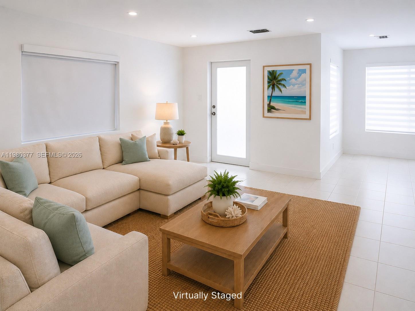 This living room features a beige sectional sofa, a wooden coffee table, and white tile floors — 1262 Marlin Dr, Marathon FL 33050, MARATHON, FL