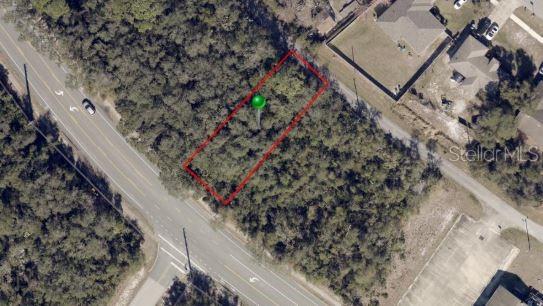 An aerial view shows a rectangular plot of land outlined in red near a road — 736 FORT SMITH BOULEVARD, DELTONA, FL
