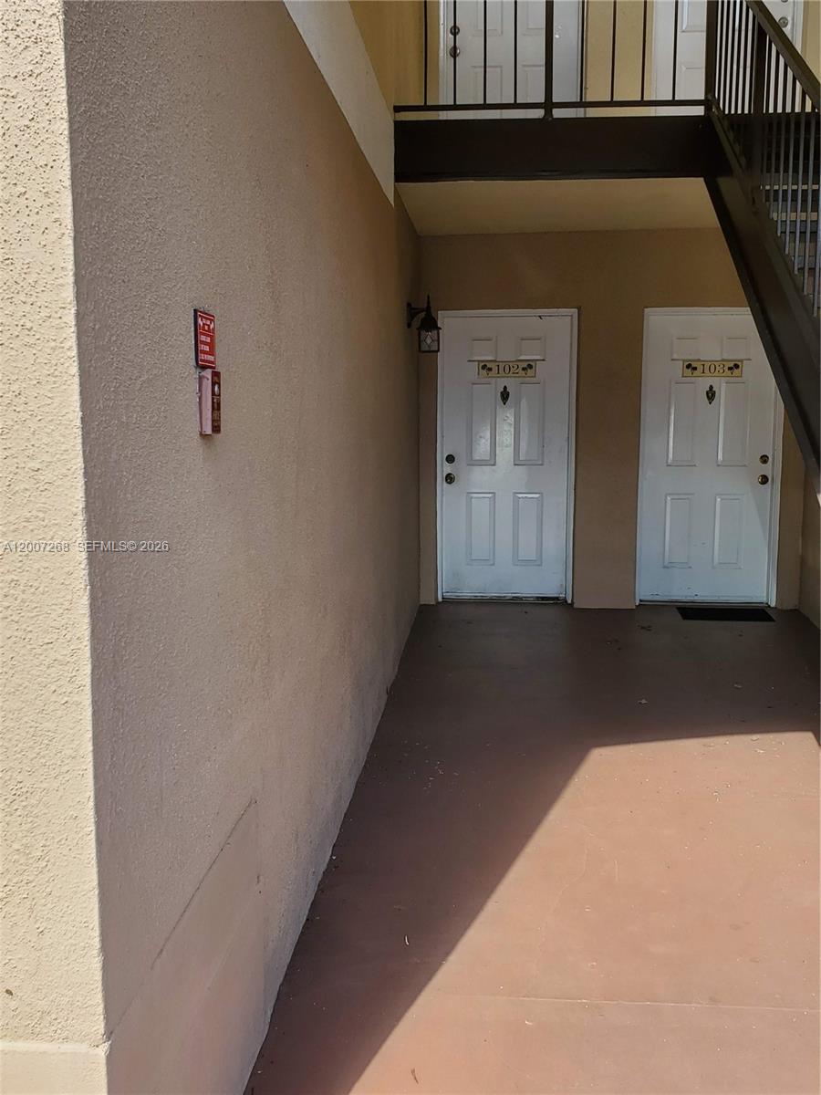 This exterior view shows two white apartment doors numbered 102 and 103 — 815 W Boynton Beach Blvd # 102, Boynton Beach FL 33426, BOYNTON BEACH, FL