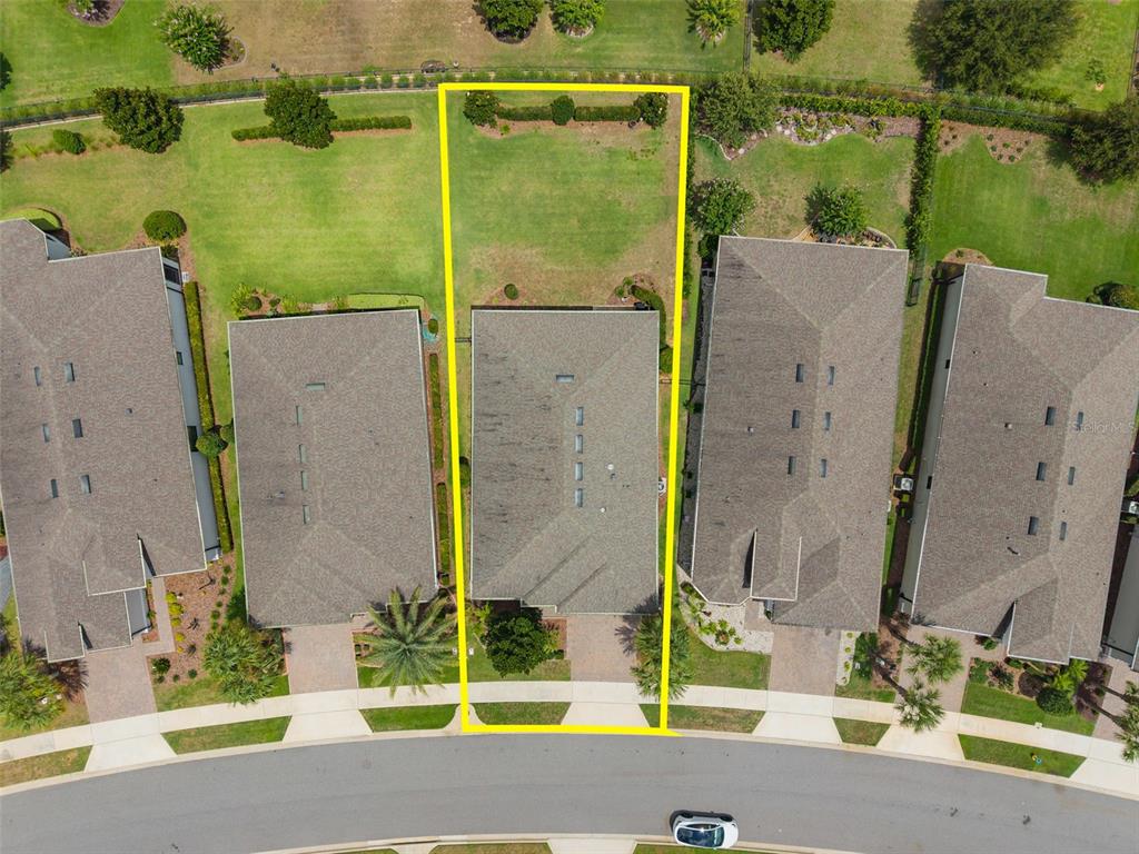 An aerial view shows a residential property lot outlined in yellow within a suburban neighborhood — 1389 ZEEK RIDGE STREET, CLERMONT, FL