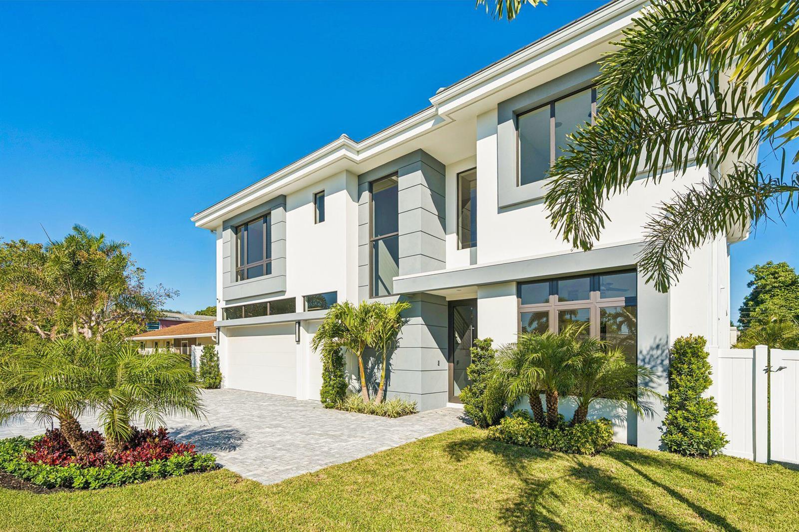 A two-story modern house with a white facade, gray accents, and a paved driveway — 261 NW 8th Street, Boca Raton FL 33432, BOCA RATON, FL