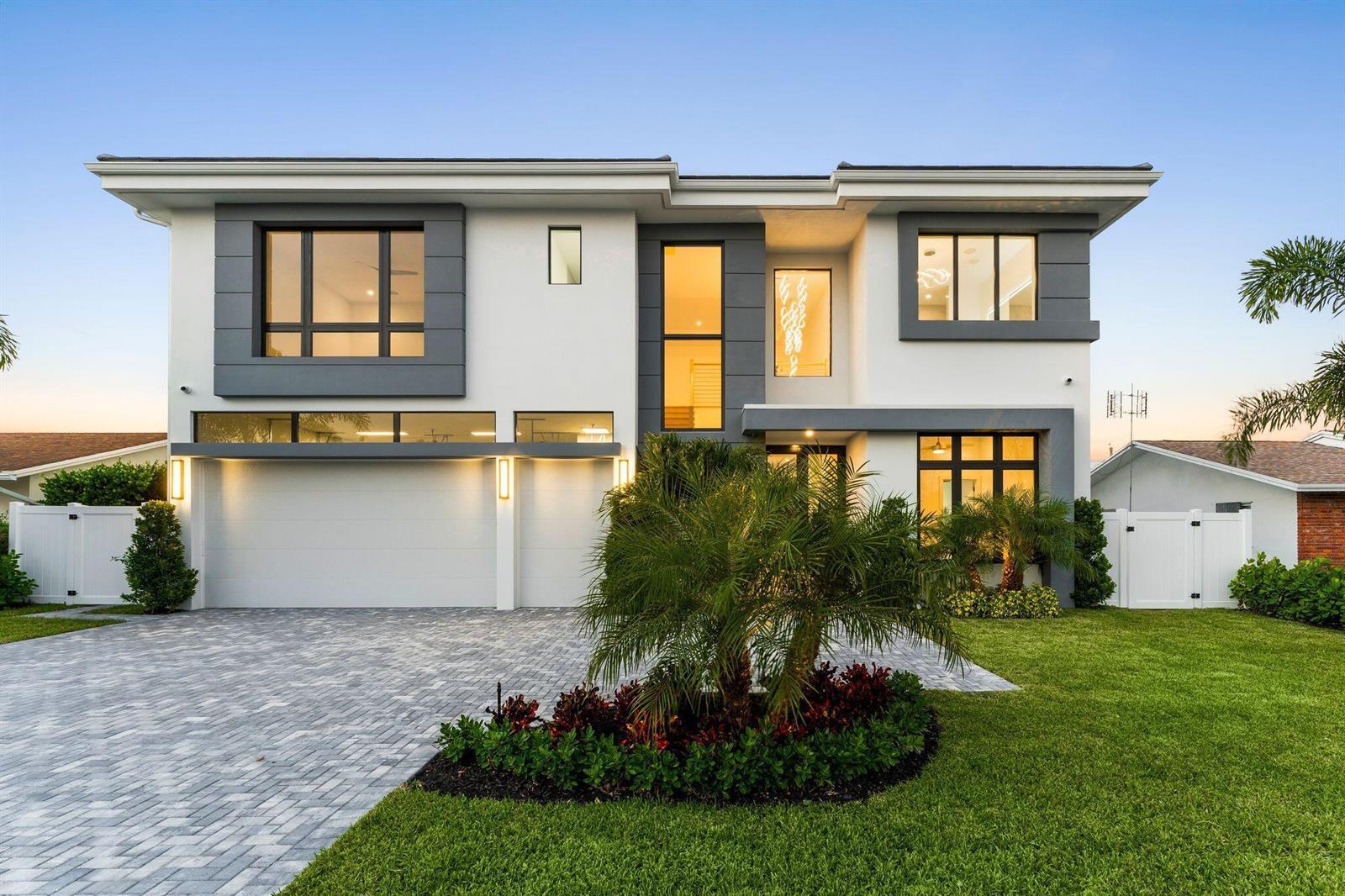 A modern two-story house with a paved driveway, white stucco exterior, and gray accents — 261 NW 8th Street, Boca Raton FL 33432, BOCA RATON, FL