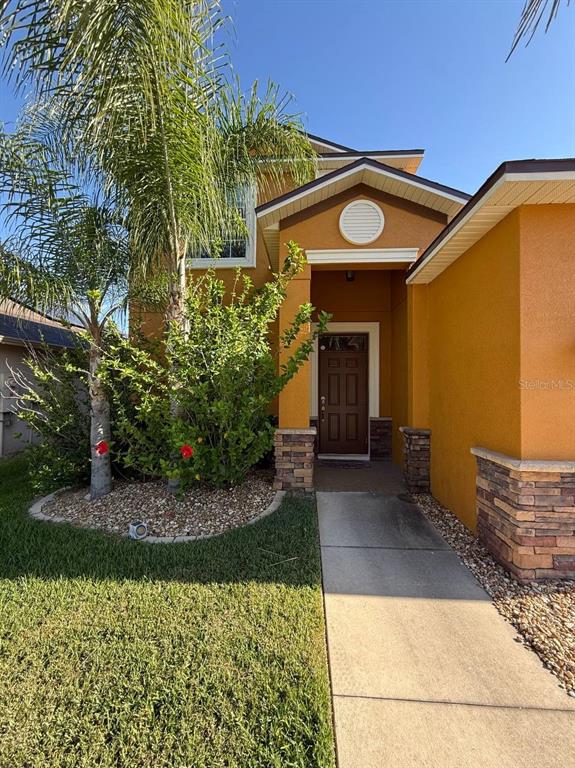 A room with beige walls, tan carpeting, a ceiling fan, and light blue built-in cabinets — 12404 BALLENTRAE FOREST DRIVE, RIVERVIEW, FL