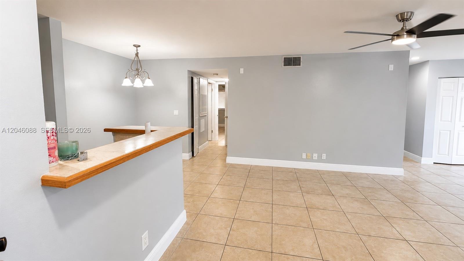 An interior room features light gray walls, tile flooring, a breakfast bar, and a ceiling fan — 2986 S University Dr # 8108, Davie FL 33328, DAVIE, FL
