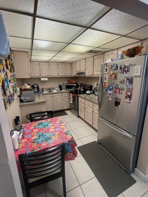 A kitchen features light-colored cabinetry, a floral-patterned dining table, and a stainless steel refrigerator — 14250 SW 62nd St # 320, Miami FL 33183, MIAMI, FL