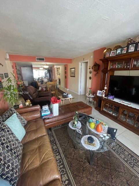 A living room features a brown leather sofa, a glass coffee table, and a large entertainment center — 14250 SW 62nd St # 320, Miami FL 33183, MIAMI, FL