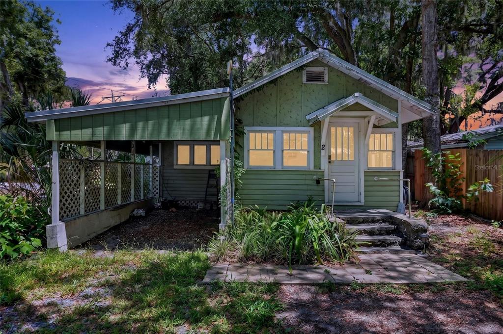 A small green house with a carport and a front porch with concrete steps — 2 ALLEY A, YANKEETOWN, FL