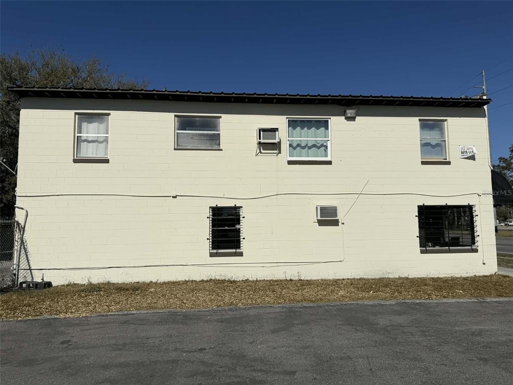 A two-story building with a light-colored concrete block exterior and several windows — 5508 EDGEWATER DRIVE, ORLANDO, FL