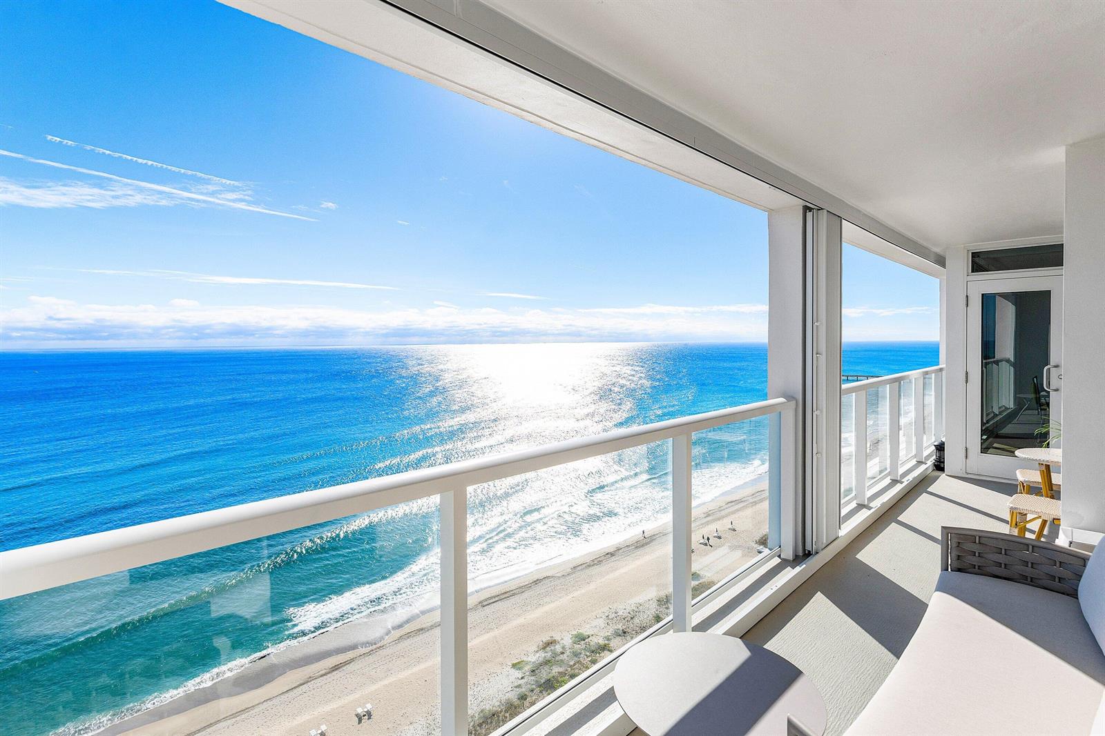 A balcony with a glass railing overlooks a sandy beach and the blue ocean — 2800 S Ocean Boulevard # c, Boca Raton FL 33432, BOCA RATON, FL
