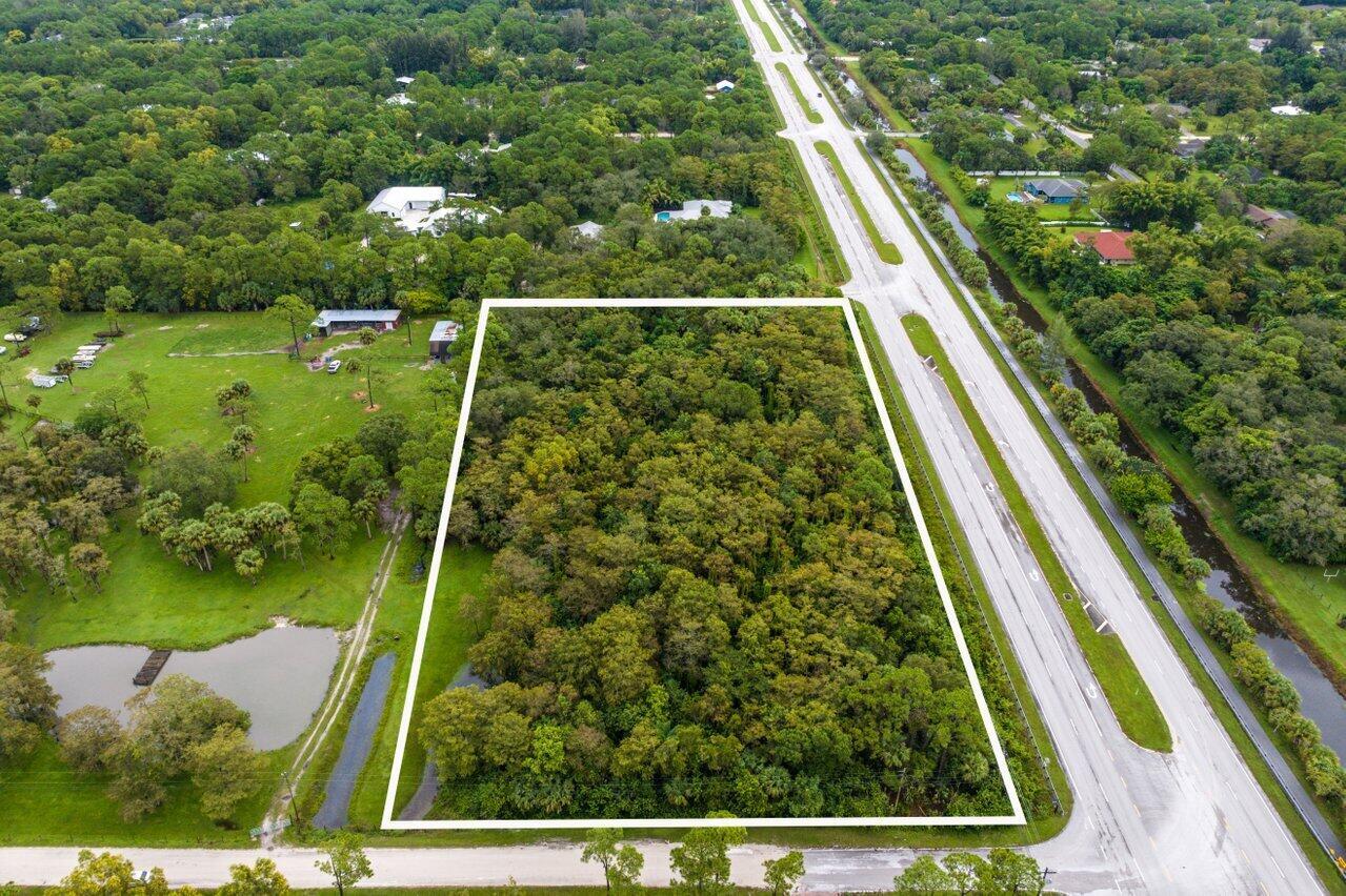 An aerial view shows a rectangular wooded lot outlined in white next to a highway — Xxxxx Indiantown Road, Jupiter FL 33478, JUPITER, FL