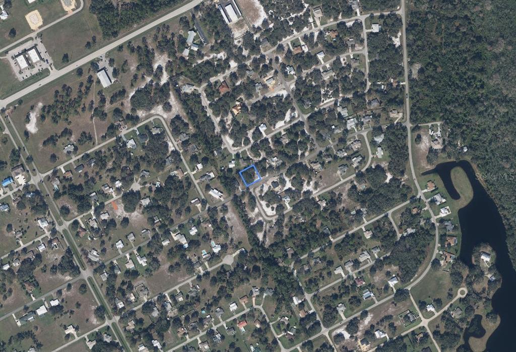 An aerial view shows a residential neighborhood with a blue outline highlighting a vacant lot — 5917 EDGEWATER TERRACE, SEBRING, FL