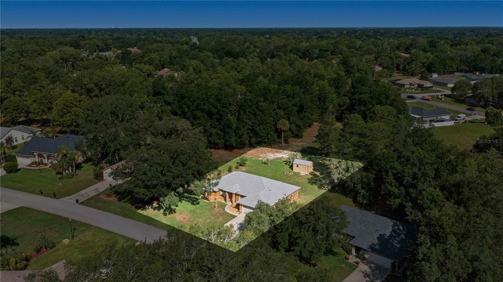 An aerial view shows a single-story house with a gray roof and a small shed — 10716 SW 53RD CIRCLE, OCALA, FL
