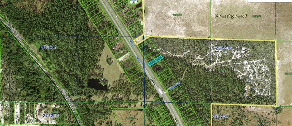 This aerial map shows a rectangular parcel of land highlighted in blue along a highway — US HIGHWAY 27, FROSTPROOF, FL