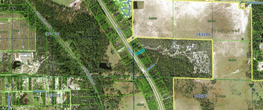 This is an aerial map showing a highlighted parcel of land adjacent to a highway — US HIGHWAY 27, FROSTPROOF, FL