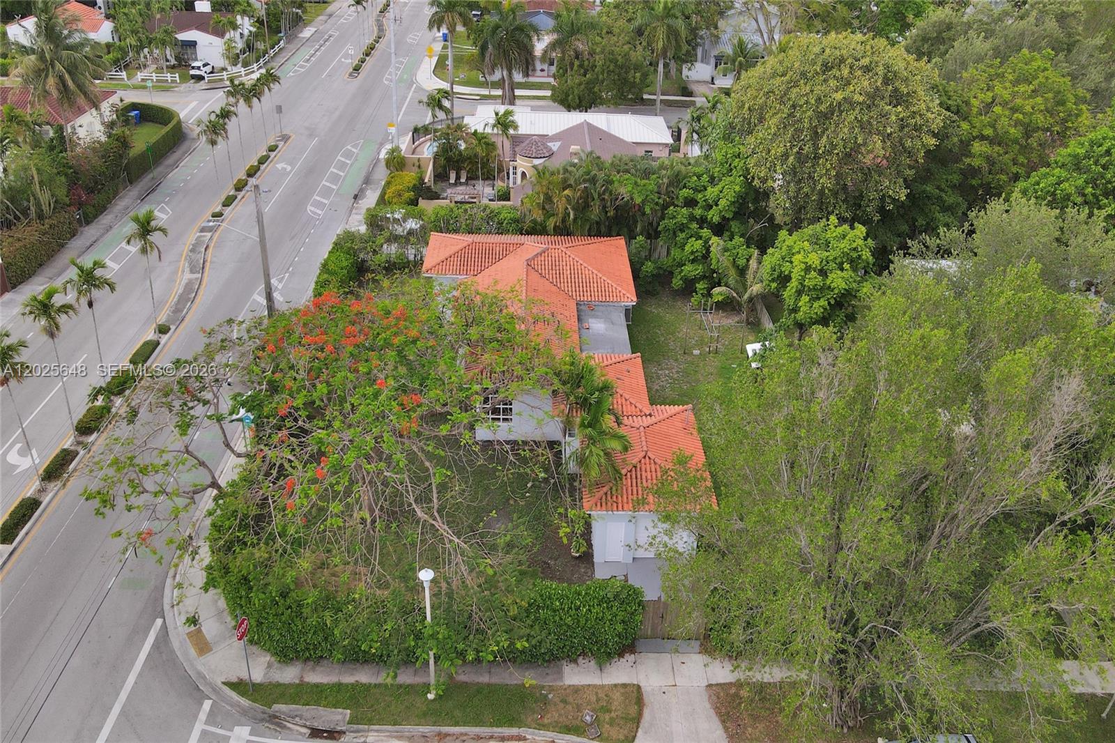 An aerial view shows a house with a red tile roof surrounded by lush trees — 2300 SW 22nd Ave, Miami FL 33145, MIAMI, FL