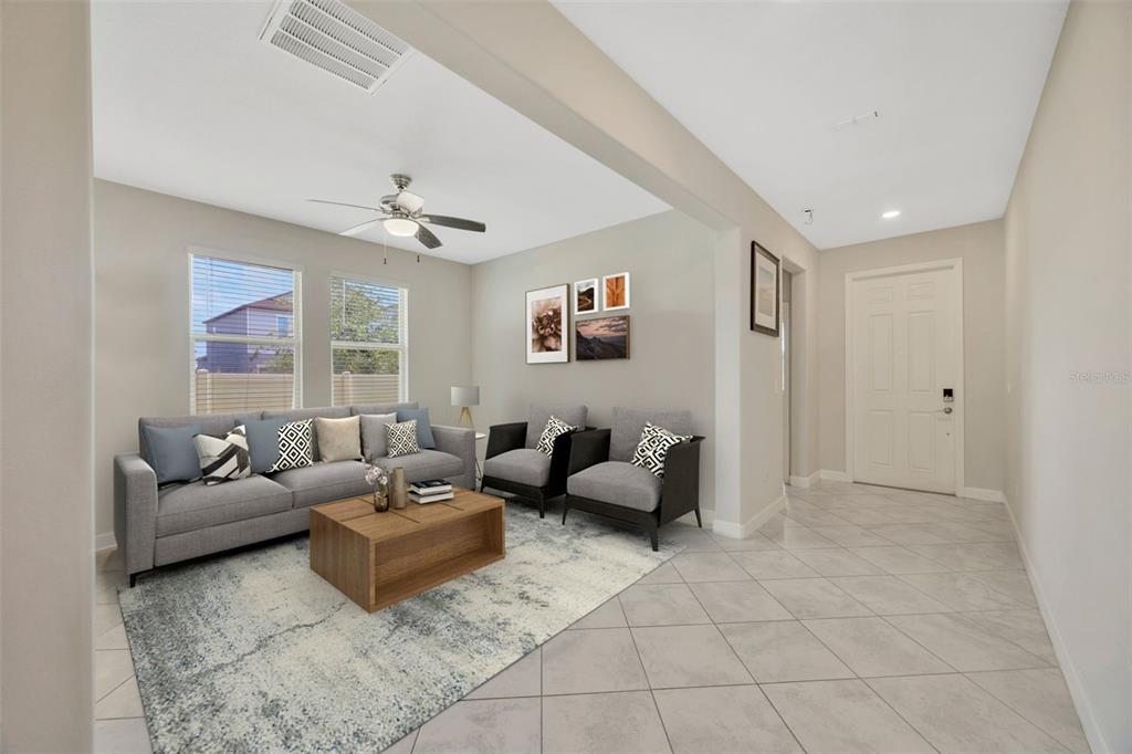 A living room features a grey sofa, two armchairs, a coffee table, and tile flooring — 11464 CHILLY WATER COURT, RIVERVIEW, FL