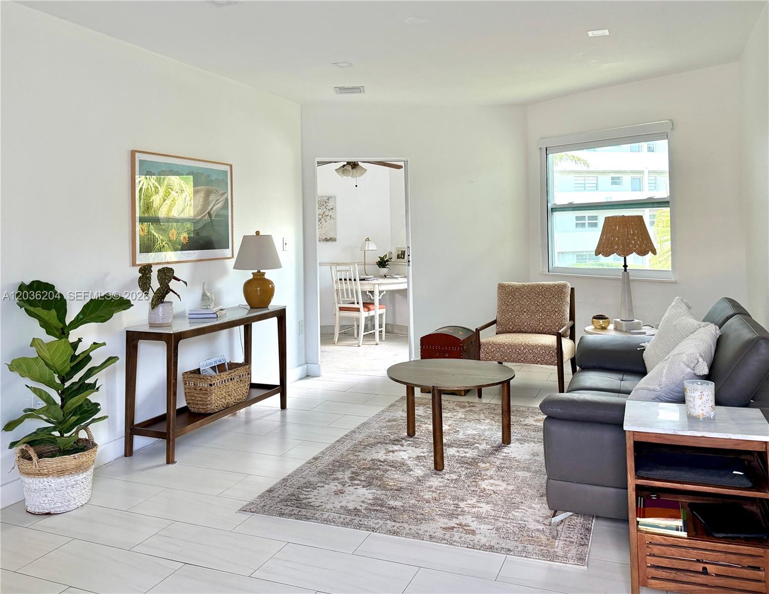 A living room features white tile floors, a grey sofa, and a wooden console table — 18750 NE 18th Ave # 251, Miami FL 33179, MIAMI, FL