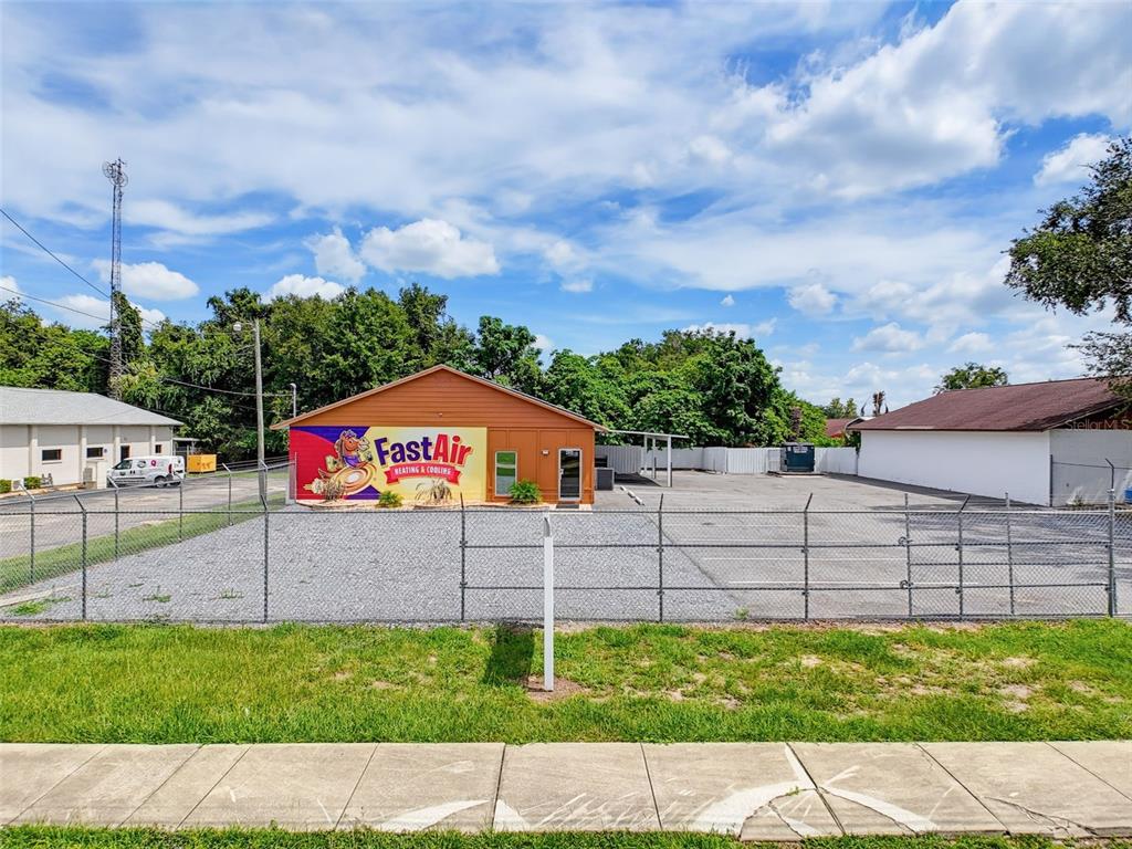 A commercial building with a FastAir sign sits behind a chain-link fence and gravel lot — 3347 SW 7TH STREET, OCALA, FL