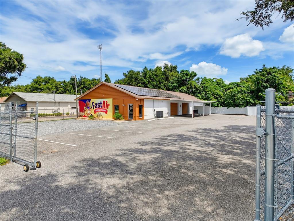 A commercial building with a FastAir sign, solar panels, and a gravel parking lot — 3347 SW 7TH STREET, OCALA, FL