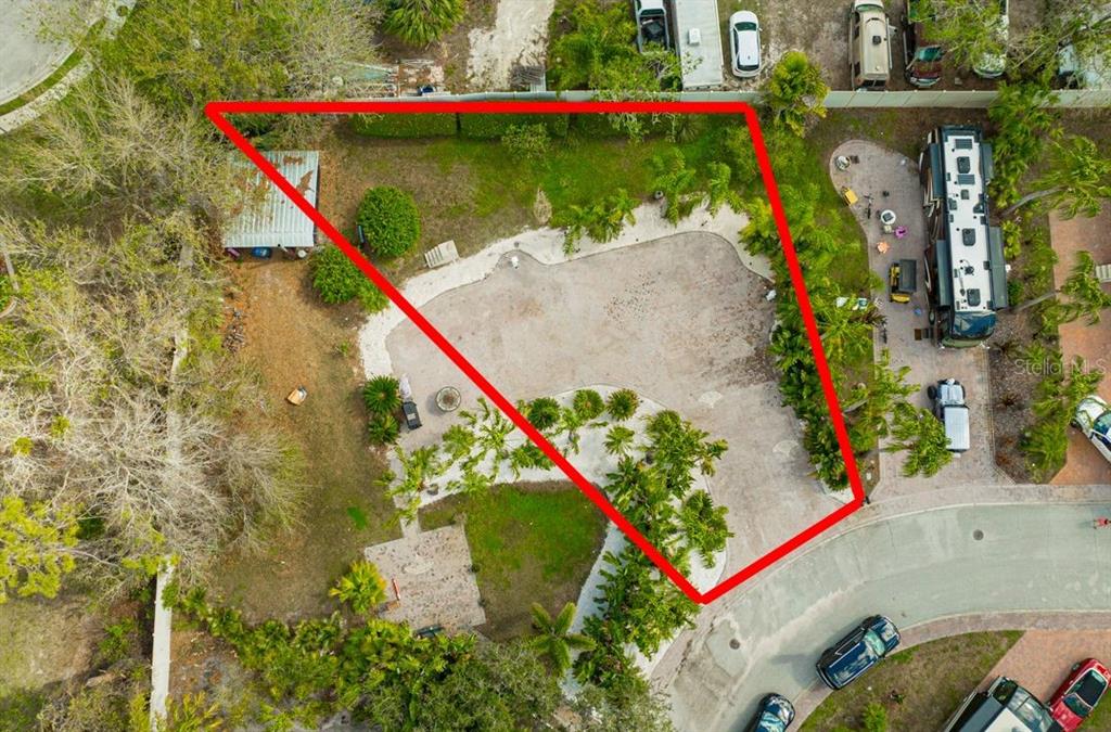 An aerial view shows a paved lot outlined in red with landscaping and a small shed — 6861 AMANDA VISTA CIRCLE, LAND O LAKES, FL