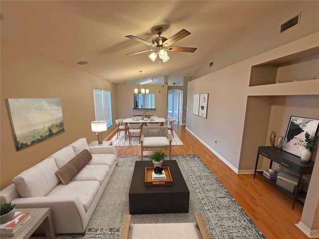 A living room and dining area feature hardwood floors, a ceiling fan, and neutral walls — 10608 NAVIGATION DRIVE, RIVERVIEW, FL