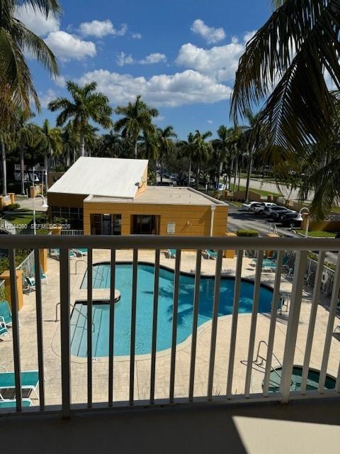 An elevated view shows a swimming pool and a clubhouse building surrounded by palm trees — 1450 SE 3rd Ave # 302, Dania Beach FL 33004, DANIA BEACH, FL
