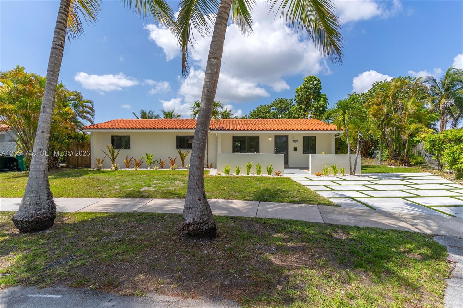 A single-story house with a terracotta tile roof and a paved driveway sits behind palm trees — 12846 SW 49th Ter, Miami FL 33175, MIAMI, FL