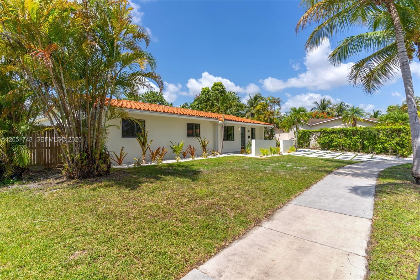 A single-story house with a terracotta tile roof sits behind a lawn and sidewalk — 12846 SW 49th Ter, Miami FL 33175, MIAMI, FL