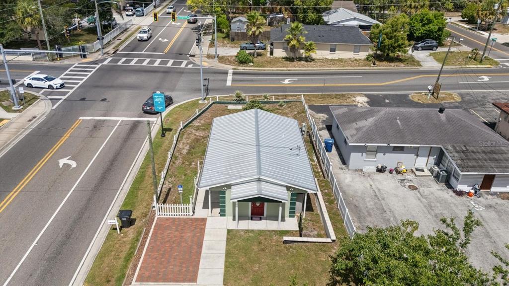 An aerial view shows a small building with a metal roof near a street intersection — 6511 MAIN STREET, NEW PORT RICHEY, FL