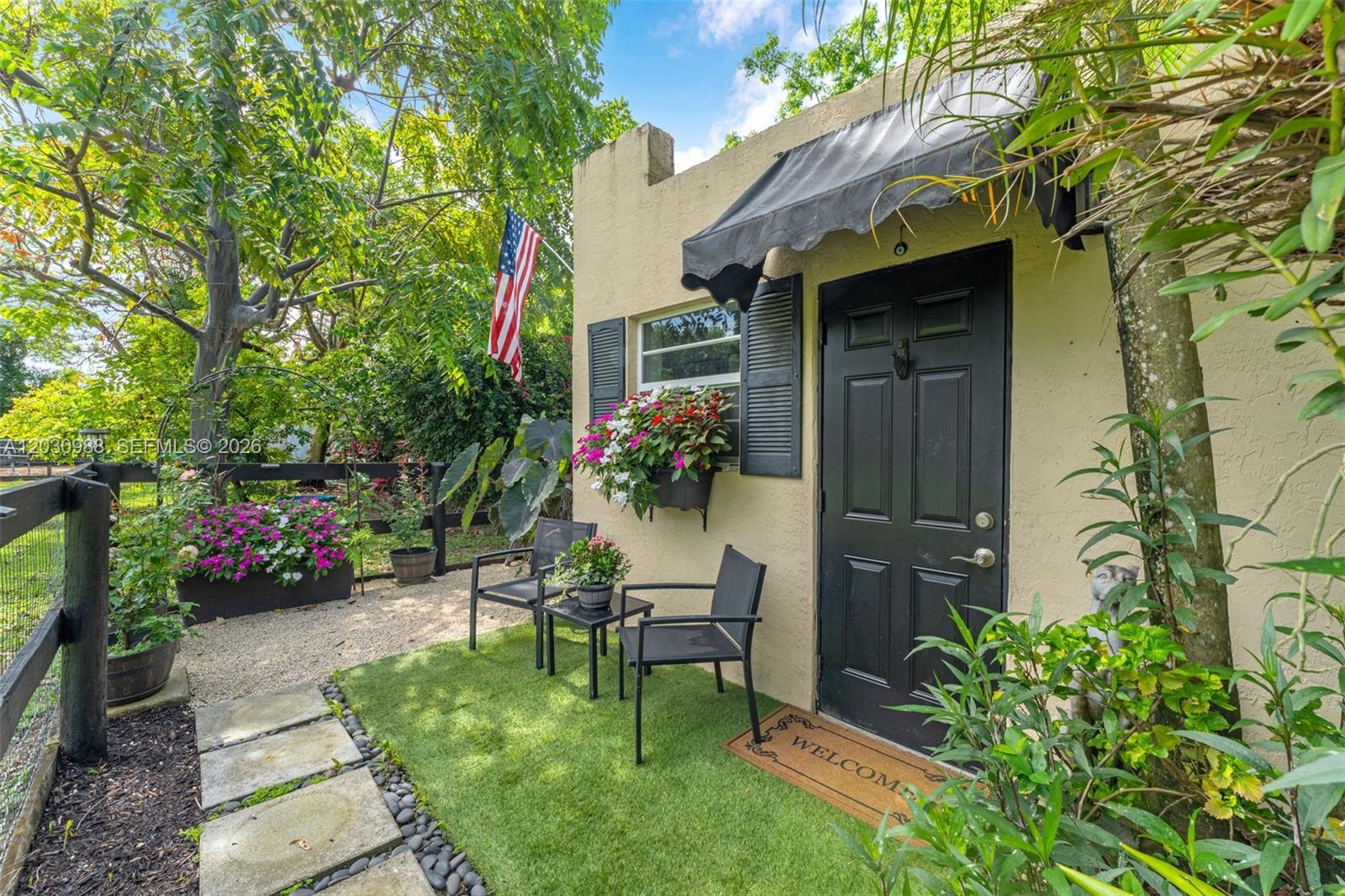 A small patio with artificial turf, two chairs, and a black door with an awning — 22065 SW 167th Ave # A, Miami FL 33170, MIAMI, FL
