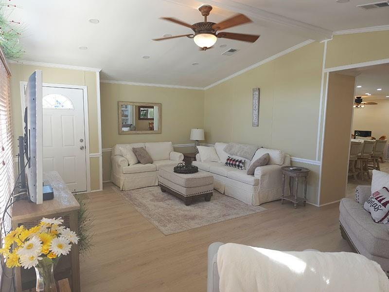 A living room features light-colored walls, white sofas, a ceiling fan, and wood-look flooring — 4300 SE Saint Lucie Boulevard # 70, Stuart FL 34997, STUART, FL