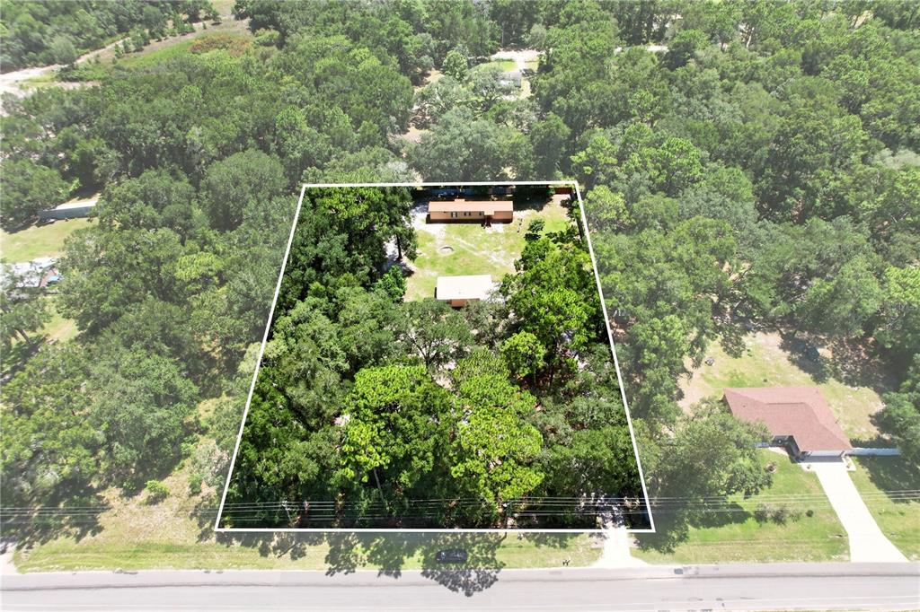 An aerial view shows a rectangular property lot containing a mobile home and outbuilding — 8200 SE 145 STREET, DUNNELLON, FL