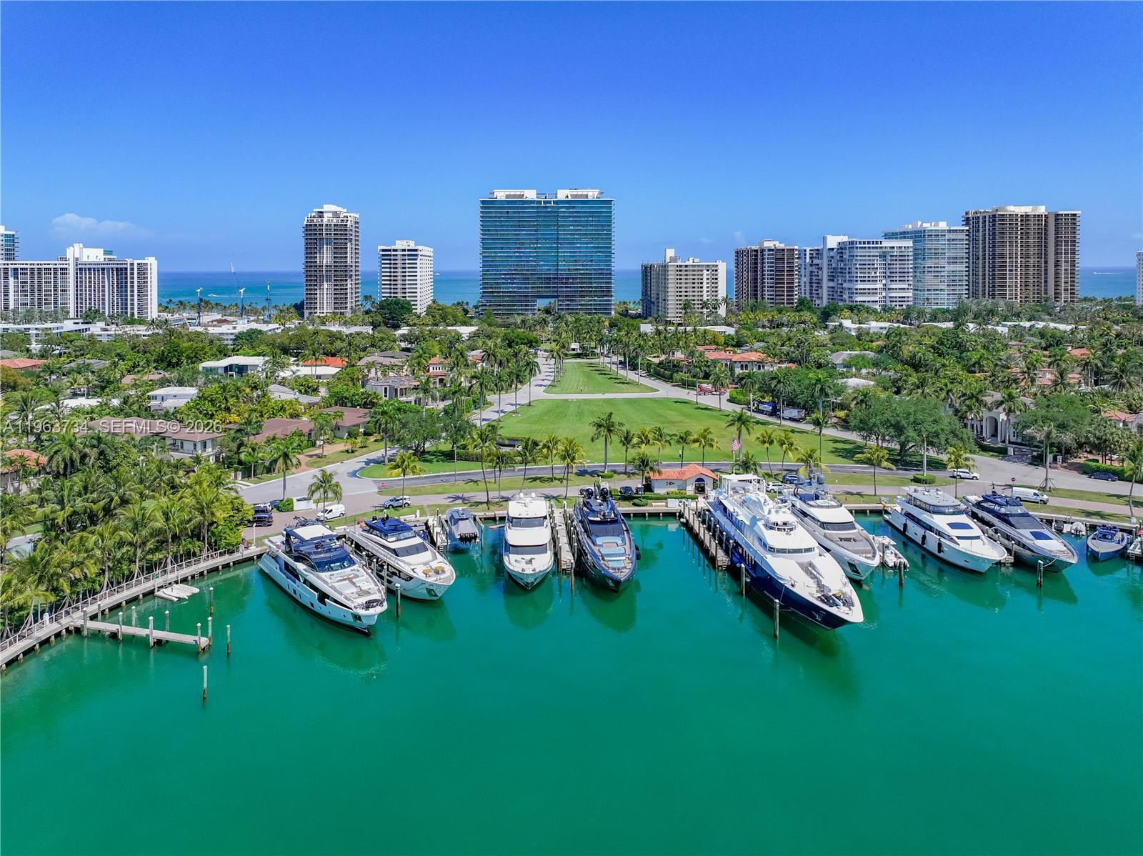 An aerial view of a marina with several yachts docked in front of coastal buildings — 10201 Collins Ave # 1205, Bal Harbour FL 33154, BAL HARBOUR, FL
