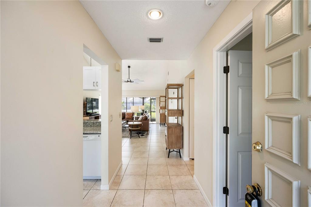 A tiled entryway leads into a living area with a kitchen visible on the left — 5370 MYRTLE WOOD ROAD UNIT 56, SARASOTA, FL