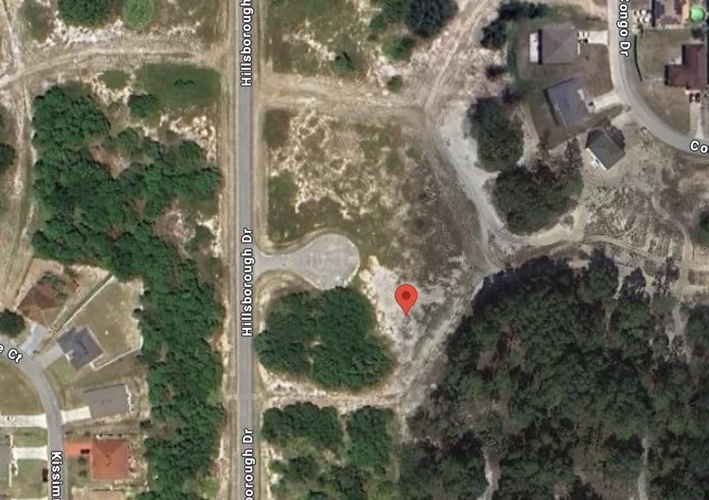 This is a satellite map view of a vacant, undeveloped residential lot — 604 HILLSBOROUGH PLACE, KISSIMMEE, FL