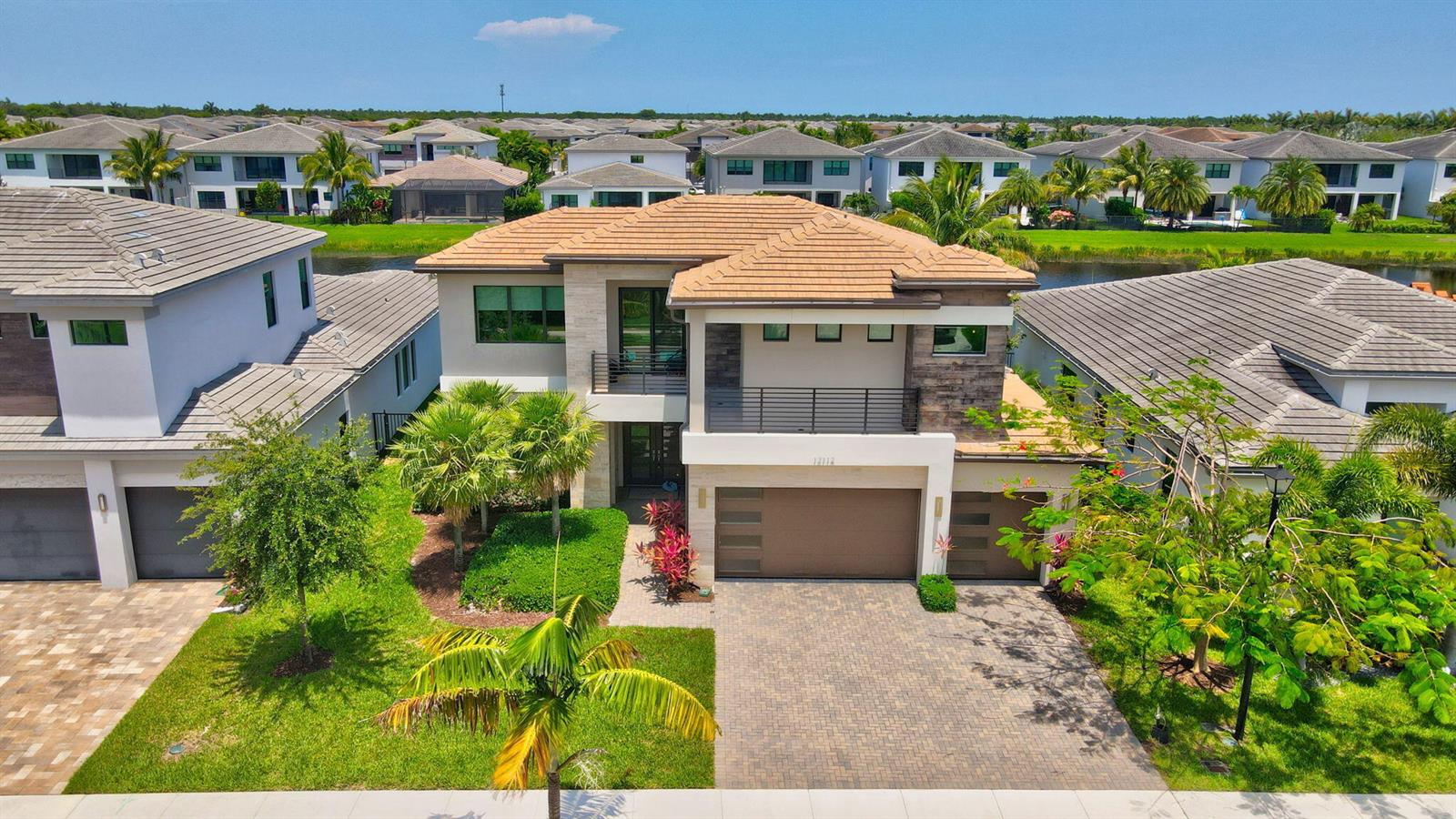 An aerial view of a two-story suburban house with a tiled roof and paved driveway — 17112 Aquavera Way, Boca Raton FL 33496, BOCA RATON, FL