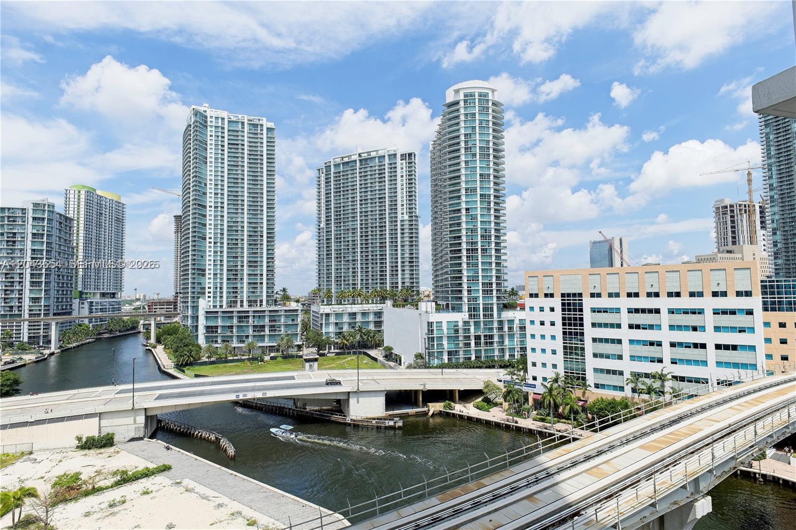 An elevated view of a city canal, bridge, and several modern high-rise residential buildings — 31 SE 5th # 1203, Miami FL 33131, MIAMI, FL