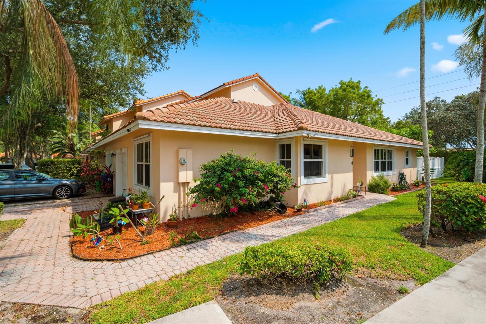 A single-story stucco house with a tiled roof, a paved walkway, and a landscaped yard — 8417 NW 40th Court, Sunrise FL 33351, SUNRISE, FL